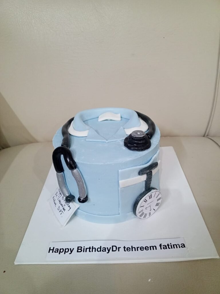 Light blue doctor scrub cake with a fondant stethoscope and personalized birthday nameplate.